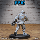 Armoured knight viewed from behind, showing a short draped cape over broad pauldrons, articulated back plate with chain links, laced leg armour, and a kite shield held at the left side. Sculpt by Epic Miniatures.