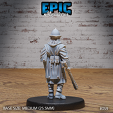 Female guard seen from behind, layered cloak with twin belt pouches visible, pointed kettle helm, long hair over shoulders, studded mace gripped at her side. Sculpt by Epic Miniatures.