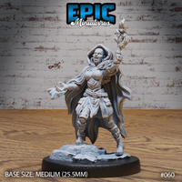 Hobgoblin female sorceress with fanged snarling expression, one hand raised with runic gauntlet and flame, clawed hand reaching forward, layered armour and billowing cloak, standing on a broken cobblestone rubble base. Sculpt by Epic Miniatures.