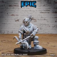 Kneeling female orc archer gripping a spear horizontally, wearing a patched travelling cloak and leather armour, quiver of arrows strapped to her back, grim determined expression. Sculpt by Epic Miniatures.