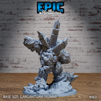 Golem miniature viewed from behind, revealing a full clock tower with pointed spire rising from its upper back, with bone-fused masonry and architectural fragments covering its body and arms. Sculpt by Epic Miniatures.