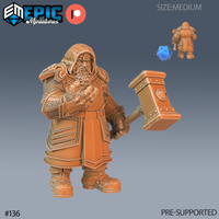 Digital render of an unpainted Nordic Dwarf miniature in orange resin, standing with a heavy riveted warhammer in one hand and the other fist drawn to his chest, wearing a deep hood over chainmail and heavy Nordic-knotwork pauldrons, with a braided beard and layered banded tunic — shown from front and rear angles with a blue d20 for scale