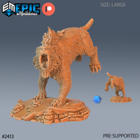 Unpainted orange resin 3D printed Sabretooth Tiger miniature in a large size, shown in a crouching snarl pose with arched back, open fanged mouth, and raised haunches on a rocky terrain base. A standard 32mm miniature and blue d20 die are shown beside it for scale comparison. Sculpted by Epic Miniatures.