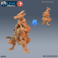 Digital render of a 32mm Winter Kobold Spy miniature — an athletic bipedal kobold gripping a small horned creature by the horns in a wrestling pose, tail curled for balance, jaws open, shown from front and rear against a grey gradient background with a blue d20 for scale reference.