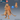 Digital render of an unpainted Winter Kobold Captain miniature at 32mm scale, shown from front and back. The kobold stands in a long woven coat with a broad collar, wearing a horned helm. A curved scimitar hangs at one side. Reptilian digitigrade legs and a tail are visible. A blue d20 die provides scale reference. Rendered in orange-tan by Epic Miniatures.