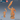Digital render of an unpainted resin half frost giant miniature in orange-tan resin, shown from front and rear. The large-scale figure is mid-attack, raising a massive serrated bone blade overhead. He wears banded leather armour, a single pauldron, and wrist wrappings, with a bare torso and long flowing beard. Base is rocky broken ground. A blue d20 and smaller rear-view pose are shown for scale reference.