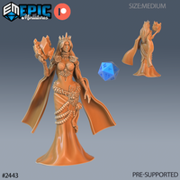 Digital render of the Ice Sorceress miniature by Epic Miniatures — a crowned female spellcaster in a flowing gown with rose-motif pauldrons and jewelled choker, raising a jagged mass of elemental ice in one hand. A blue d20 provides scale reference. Front and rear views shown. Pre-supported, medium size, 32mm scale.