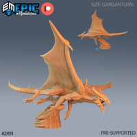 Gargantuan dragon sculpt perched on a rocky base, wings fully spread with veined membranes, jaws open wide, neck spurred with ridges. By Epic Miniatures.