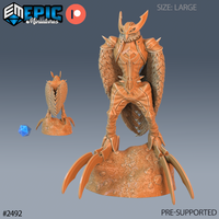 Armoured owl harpy standing upright on a rocky base, broad feathered wings swept back, wearing a horned beaked helmet and overlapping scale-plate armour, with large raptor talons gripping the stone. Sculpt by Epic Miniatures.