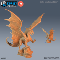 Gargantuan dragon rearing upright on a rocky base, wings spread wide with ribbed membrane and talon-tipped finger-bones, one foreleg raised, jaws parted, dorsal spines running the full length of the back. Sculpt by Epic Miniatures.