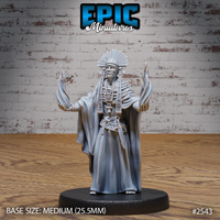 Robed shaman chief with arms raised wide, ghostly flames rising from both hands, wearing a broad feathered headdress with hanging pendants and layered beaded pectoral jewellery. Sculpt by Epic Miniatures.