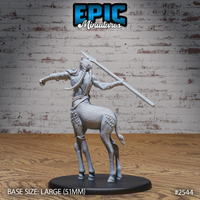 Giraffe centaur warrior seen from behind, a thick braided rope crossing the bare back, spear raised overhead in a throwing stance. Textured hide with raised studs across the haunches, a flowing tail behind the hooved legs. Sculpt by Epic Miniatures.