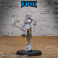 Female tribal warrior-mage striding forward, right hand raised with conjured magic at her fingers, left hand gripping a heavy axe. Long braided hair, layered bead necklaces, tattered skirt, cord-wrapped ankles. Rocky sculpted base. By Epic Miniatures.