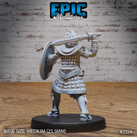 Armoured tribal warrior seen from behind mid-swing, sword raised high over the right shoulder, round shield gripped at the left arm, layered scale armour covering the torso and legs, broad scale pauldron visible. Sculpt by Epic Miniatures.