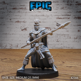 Muscular tribal warrior thrusting a rope-bound spear forward with both hands, wearing a feathered headdress, layered bead necklaces, a flowing full-length cape, and rope-fringed ankle wrappings. Sculpt by Epic Miniatures.