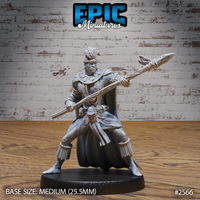 Muscular tribal warrior thrusting a rope-bound spear forward with both hands, wearing a feathered headdress, layered bead necklaces, a flowing full-length cape, and rope-fringed ankle wrappings. Sculpt by Epic Miniatures.