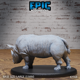 Unpainted grey resin rhino miniature in a broad, weight-bearing stance with head down and tail raised, displaying heavily folded skin texture across the shoulders and flanks. Mounted on a large oval base. By Epic Miniatures.