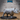 Rhinoceros miniature by Epic Miniatures, sculpted mid-stride with head lowered, prominent double horn, detailed wrinkled hide across the barrel body, on a large oval base.