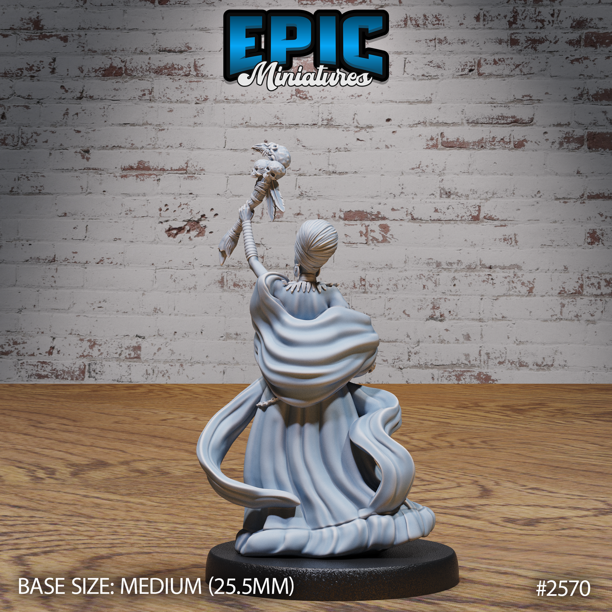 Female spellcaster seen from behind with one arm raised high holding a skull-topped staff, long flowing robes pooling around the base, wrapped hair visible, wide shoulder collar detailed across the back. Sculpt by Epic Miniatures.