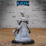 Regal female figure in a floor-length gown patterned with carved bones, wearing a feathered collar and holding a serpent-topped staff. Skull charms hang from her waist chain. Sculpt by Epic Miniatures.