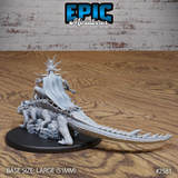 Rear view of voodoo priest on crocodile mount showing a long flowing cape, spiked bone headpiece, and the full length of the crocodile's ridged scaly tail extending behind the base. Sculpt by Epic Miniatures.