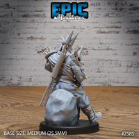 Tribal champion figure from behind, back loaded with bundled bone-tipped spears, a tied pack, and layered bone spikes rising from the shoulders beneath a feathered headdress. Sculpt by Epic Miniatures.