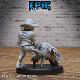 Halfling villager pushing a weathered wooden wheelbarrow, seen from behind, coat fabric detailed with folds, hairy bare feet visible at the base. Barrow holds bundled produce. Sculpt by Epic Miniatures.