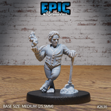 Halfling villager miniature leaning on a shovel planted in a dirt mound, raising one hand with sculpted smoke wisps, wearing a buttoned waistcoat and trousers, with curly hair and bare broad feet. Sculpt by Epic Miniatures.