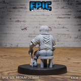 Halfling villager miniature by Epic Miniatures shown from behind, seated on a low wooden stool with a walking stick visible at his side, wearing a loose shirt with braces crossing the back, long hair falling to the nape of the neck.