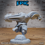 Armoured beast miniature seen from behind mid-leap, broad segmented plate shoulders and armoured forearms visible, one clawed hand reaching forward, flowing fabric at the waist, rocky base below. Sculpt by Epic Miniatures.