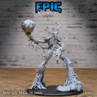 Huge treant miniature, arm outstretched holding a jagged boulder aloft, gnarled bark-textured body with leaf sprigs, roots erupting from base. Sculpt by Epic Miniatures.
