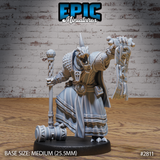 Lizardman Tribe Commander by Epic Miniatures — rear view showing heavy horned head, rope-bound belt adornments, flowing multilayered robes, and a heavy warhammer resting on the ground beside him.