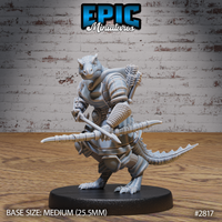 Lizardman warrior viewed from behind, revealing a large arrow-filled quiver across his broad armoured back, segmented plate covering his shoulders, crested head and scaly tail visible below the kit. Sculpt by Epic Miniatures.