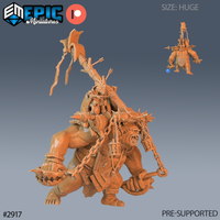 Unpainted orange resin render of a huge troll miniature carrying a goblin archer aloft on a long pole. The troll is roaring, armoured with scavenged plate and leather, and adorned with spiked chains, a hanging cage flail, and bound arrows. A small goblin clings to the pole and draws a bow mid-flight. Scale reference die visible in inset image.