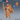 Digital render of an unpainted hobgoblin adventurer miniature at 32mm scale, shown in terracotta resin tone. The figure stands in a confident mid-stride pose, holding a tall gnarled staff in one hand and wearing a billowing travel cloak. A large wooden-framed pack is strapped to his back. He wears a studded belt with a skull charm, layered travelling clothes, and wrapped leg bindings. A blue d20 and a rear-view of the miniature are visible alongside the main figure. Epic Miniatures logo in top-left corner.