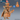 Digital render of an unpainted resin Voodoo Goblin miniature at 32mm scale — a cackling female goblin witch crouching forward in tattered zigzag-hem robes, wearing an oversized top hat decorated with a carved skull and jutting pin, clutching a button-eyed straw voodoo doll in her skeletal hands; front and rear views shown alongside a blue d20 for scale