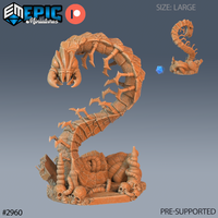 Large resin miniature of a cave centipede rearing up from a skull-strewn scenic base, showing the full segmented body, hooked legs, and fang-lined head — digital render in orange resin, unpainted, with a scale die reference shown beside a smaller variant of the same sculpt