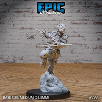 Snarling female werewolf warrior mid-leap, knee raised, wielding a spear in one hand and a bladed weapon in the other, wearing spiked plate armour with claw motifs, mounted on a snow-covered rocky base. Sculpt by Epic Miniatures.