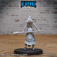 Female wizard in layered plate armour seen from behind, long hair falling to mid-back, gripping a crystal-tipped staff horizontally at waist height, skirt flowing to armoured greaves. Sculpt by Epic Miniatures.