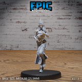 Female wizard striding forward, both hands raised with claw-tipped gauntlets, wearing a spiked crown, long flowing robes, and an armoured belt. Sculpt by Epic Miniatures.