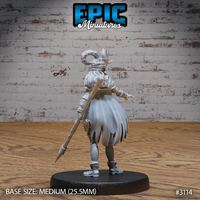 Female druid miniature seen from behind, showing a full billowing cloak, wrapped bracers, horned helm with curved ram horns, and a spear-tipped staff held at her side. Sculpt by Epic Miniatures.