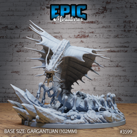 Unpainted grey resin Ancient Remorhaz miniature by Epic Miniatures, front view — gargantuan creature rearing up on articulated insectoid legs with serrated dorsal fins spread wide, fanged maw open, mounted on a 102mm scenic base strewn with shattered bones and fractured rock