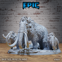 Unpainted grey resin woolly mammoth family miniature by Epic Miniatures — large matriarch with curved tusks at centre, tusked adult male to left with lowered head, small calf to right, all on a 76.5mm integrated rocky icy terrain base
