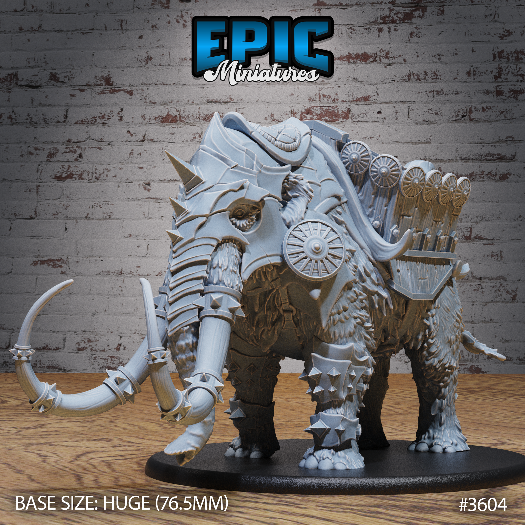 Unpainted grey resin war mammoth miniature on a 76.5mm Huge base, shown from the front-left angle. The mammoth wears full spiked iron barding with bladed tusk-caps, layered armour plates across its legs and face, and a detailed howdah loaded with crossbow racks and shield rails. A cloaked rider figure is visible at the front of the platform.