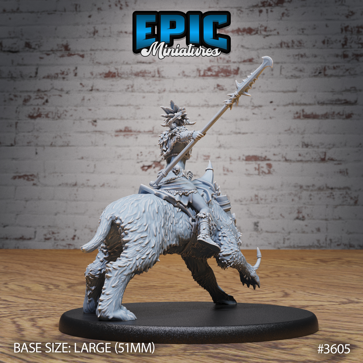 Rear three-quarter view of the same unpainted grey resin barbarian rider miniature, showing the layered spiked armour barding across the sabre-tooth's back, the rider's cape, and the detail of the war saddle and tribal metalwork. The creature's heavily muscled haunches and tail are clearly visible.