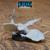 Unpainted grey resin white dragon wyrmling miniature by Epic Miniatures, shown from the front-left angle — crouching low with wings spread wide, ridged tail raised vertically, thick scaled body on a medium 25.5mm round base