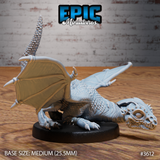 Unpainted grey resin white dragon wyrmling miniature by Epic Miniatures, photographed from the front-right — clearly showing the domed skull, bulging reptilian eye, spiked head detail, individual body scales, and outstretched wings on a medium 25.5mm round base