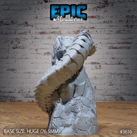 Rear three-quarter view of the unpainted grey resin Frost Worm Climbing miniature by Epic Miniatures — showing the layered dorsal scales, coiling body mass, and sweeping tail detail on the 76.5mm Huge base