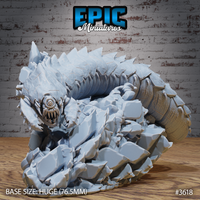 Front-facing digital render of the Epic Miniatures Frost Worm miniature — a colossal armoured worm coiled atop shattered ice and rock rubble, showing a single cyclopean eye, gaping multi-fanged maw, and heavily plated body. Huge scale, 76.5mm base, unpainted grey.