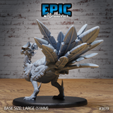 Unpainted grey resin Turkey Raptor miniature from Epic Miniatures, rear three-quarter view — showing the full layered feather fan spread wide, overlapping scaled body texture, reverse heel spurs on taloned feet, and 51mm large round base